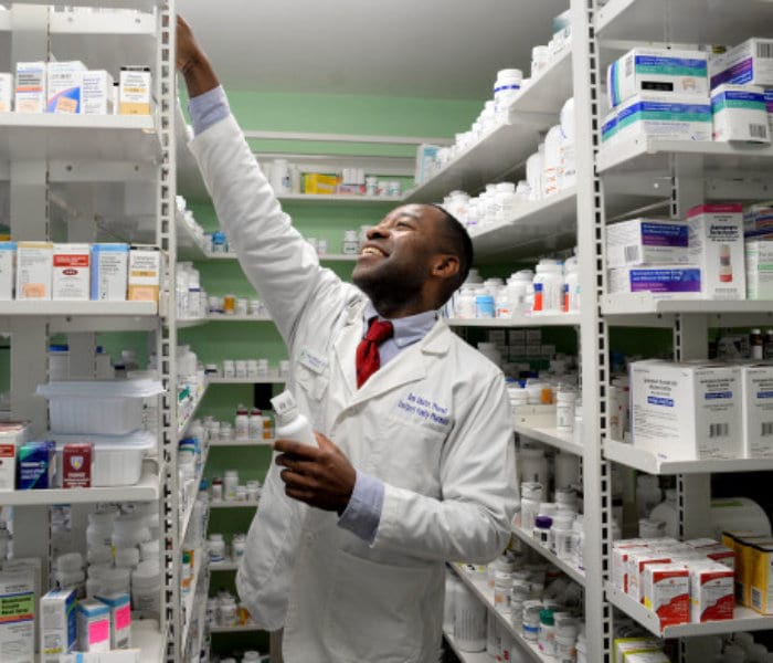 pharmacist looking something in the shelves